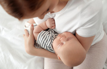 Sticker - Mother with her baby on bed, above view