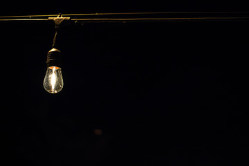 lamp on wire at night