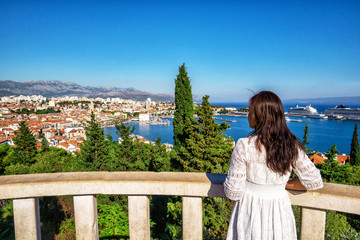 Woman traveler travel to old town of Split in Dalmatia, Croatia. Split is the famous city and top tourism destination of Croatia and Europe.