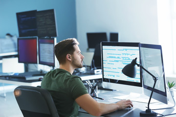 Wall Mural - male programmer working in office