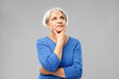 © Syda Productions - old people and decision making concept - portrait of senior woman in blue sweater thinking over grey background