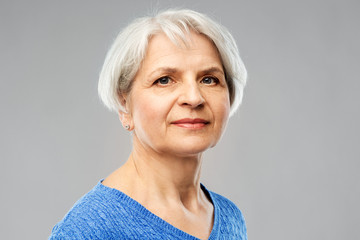 Poster - old people concept - portrait of senior woman in blue sweater over grey background