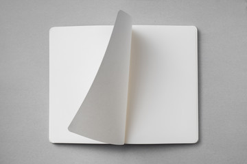 white notebook with turn page on grey background