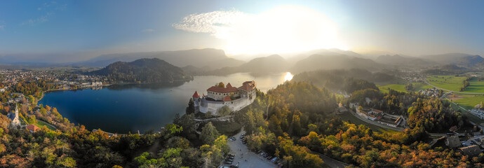 Wall Mural - Aerial view of medieval castle by the lake Bled in Slovenia. Beautiful nature of Slovenia in fall.