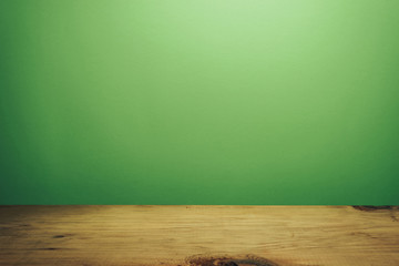 Beautiful brown wooden table and green wall background.