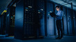 © Gorodenkoff - In Data Center: Male IT Technician Running Maintenance Programme on a Laptop, Controls Operational Server Rack Optimal Functioning. Modern High-Tech Telecommunications Operational Super Computer.
