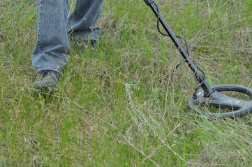 metal detector at work searching in the grass