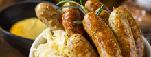 Traditional German Sausages With Cabbage Salad, Mustard And Beer. Bratwurst And Sauerkraut.