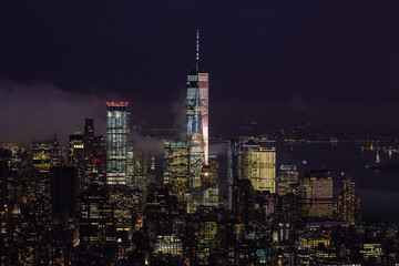 Fototapete - New York City skyline with lower Manhattan skyscrapers in storm at night.