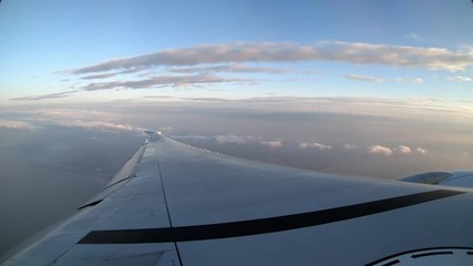 Wall Mural - 4K, Aerial view of beach in Taiwan island. See the wing of a plane as seen through airplane window. Passenger POV traveling by air. Aircraft during the flight with grey sky and clouds. -Dan