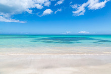 Looking Out To Sea From An Idyllic Sandy Beach On The Island Of Antigua