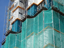 Catch Platform And Safety Netting At The Face Of The Building During High-rise Building Construction. It Protects Individuals And Property From Falling Debris. 