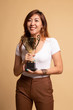 Successful young asian woman holding a trophy.