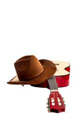Fototapete - American culture, folk song and country muisc concept theme with a cowboy hat and an acoustic guitar isolated on white background with a clip path cut out