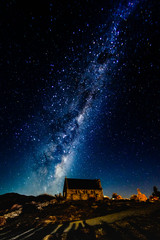 Fototapete - Backgrounds night sky with stars and milky way over the church at tekapo lake south island new zealand