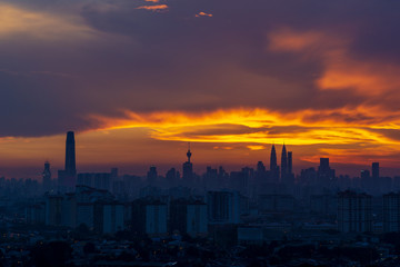 Majestic sunset over downtown Kuala Lumpur, a capital of Malaysia. Its modern skyline is dominated by the 451m-tall Petronas Twin Towers.