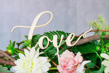 Canvas Print - Wooden word love in front od flower background