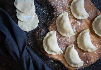 Raw dumpling with potatoes. Preparation dumplings on a wooden board