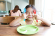 © kornnphoto - Asian children cute hungry or kid girl holding colorful spoon and fork with dish for wait eat delicious food with smiling and happy for enjoy lunch or breakfast in morning at restaurant or food court