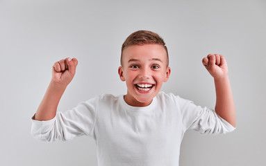 Wall Mural - Cute boy on a gray background