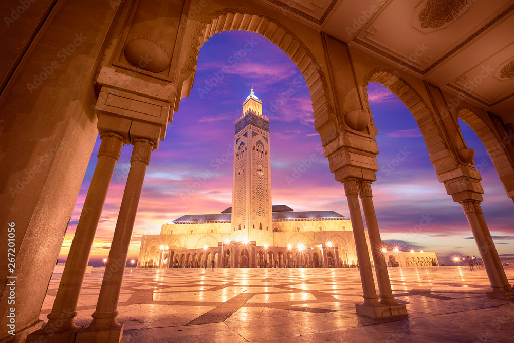 The Hassan II Mosque at sunset in Casablanca, Morocco. Hassan II Mosque is the largest mosque in Morocco and one of the most beautiful. the 13th largest in the world. - obrazy, fototapety, plakaty 