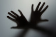 © Алексей Р - shadow hands of the man behind frosted glass. blurry hand abstraction halloween, silhouette of a hand blur shadow of a blurry hand behind the glass.