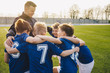 © matimix - Group Of Children In Soccer Team Celebrating With Coach