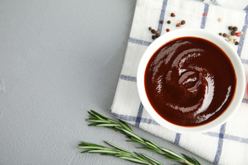 Flat lay composition with barbecue sauce on grey background. Space for text