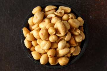 Wall Mural - Roasted salted peanuts in coconut bowl, pub snack