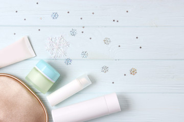 Wall Mural - Winter care cosmetics on a colored background top view.