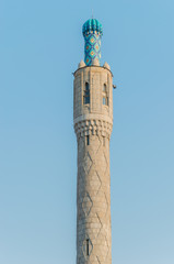 The majestic minaret of the cathedral mosque against the blue sky.