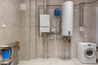 © alhim - Wall hung gas boiler and electric water heater in boiler room