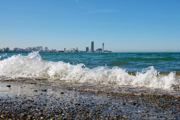 Wall Mural - Blurred City line behind the waves