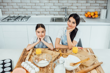 Happy family!f Funny sisters  are preparing the dough, will  bake cookies in the kitchen !