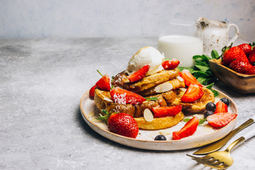 Wall Mural - Stecked french toast topped with strawberries, blueberries, mint, ice cream and maple syrup