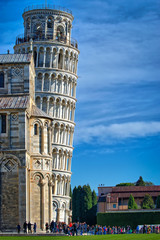 Wall Mural - A beautiful day in Pisa. In the background many tourists enjoying the leaning tower.