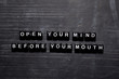 © syahrir - Open your mind before your mouth on wooden blocks. Education, Motivation and inspiration concept
