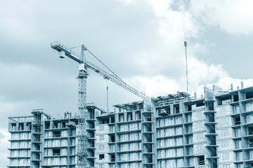 construction of new apartment building with yellow tower crane