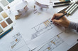 © Chaosamran_Studio - architect design working drawing sketch plans blueprints and making architectural construction model in architect studio