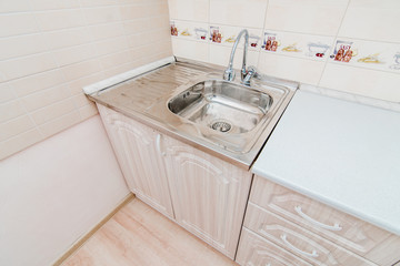 The photo of a sink in a The photo of a sink in a  kitchen