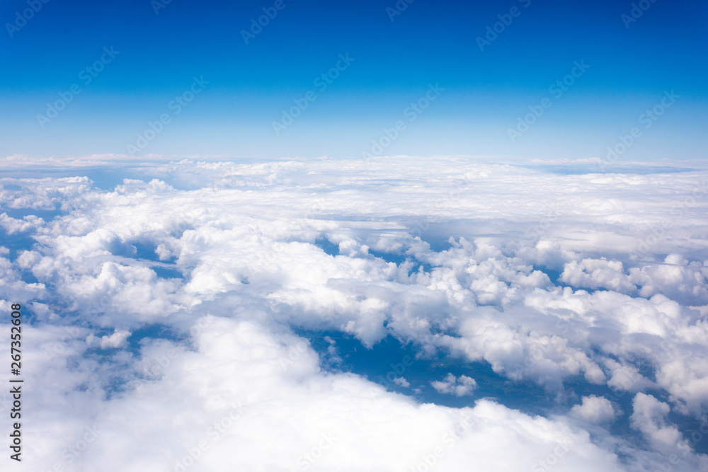 Earth in the airplane window with clouds - obrazy, fototapety, plakaty 