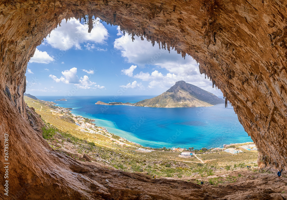 The famous "Grande Grotta", one of the most popular climbing fields of Kalymnos island, Greece. In the background, Telendos island. - obrazy, fototapety, plakaty 