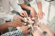 © yurolaitsalbert - close up. business team sitting at the table and collecting puzzle