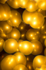 Wall Mural - Decorative golden color bubbles bokeh on a black background. Lights for christmas