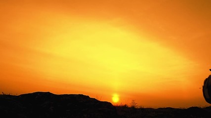 Wall Mural - young happy travelers hiking with backpacks on the rocky trail at summer sunset. family travel and a