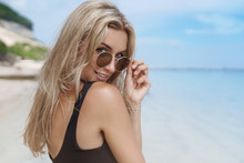 Woman Suggest Come Travel. Charming Alluring Young Flirty Blond Girlfriend Take Off Glasses Turn Back Look Camera Coquettish, Walk Sandy Beach Enjoy Ocean View, Sunbathing Resting Vacation