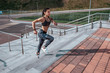 © byswat - Girl athlete woman, runs stairs, summer city, free space, fitness workout, day morning. Sportswear top sneakers. Active lifestyle, motivation power. Endurance achievement success, muscles competitions