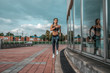 © byswat - Girl morning run summer city background steps clouds metal handrails. Phone headphones music playlist. Fitness sport active lifestyle young people. Motivation power achievement success. Free space.