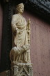 Rouen, France : In the courtyard of The Rouen Cathedral. The stone statue of St. Romain (Archbishop of Rouen) with a terrible dog by his foot