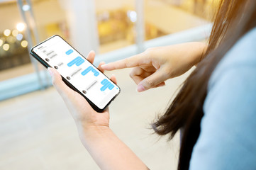 Woman using her mobile smartphone. She chatting with friend on mobile phone